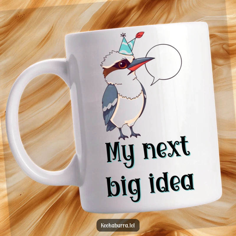 Funny Kookaburra Mug: Excitedly wearing a party hat, pointing quill at a blank speech bubble, ready to write jokes.