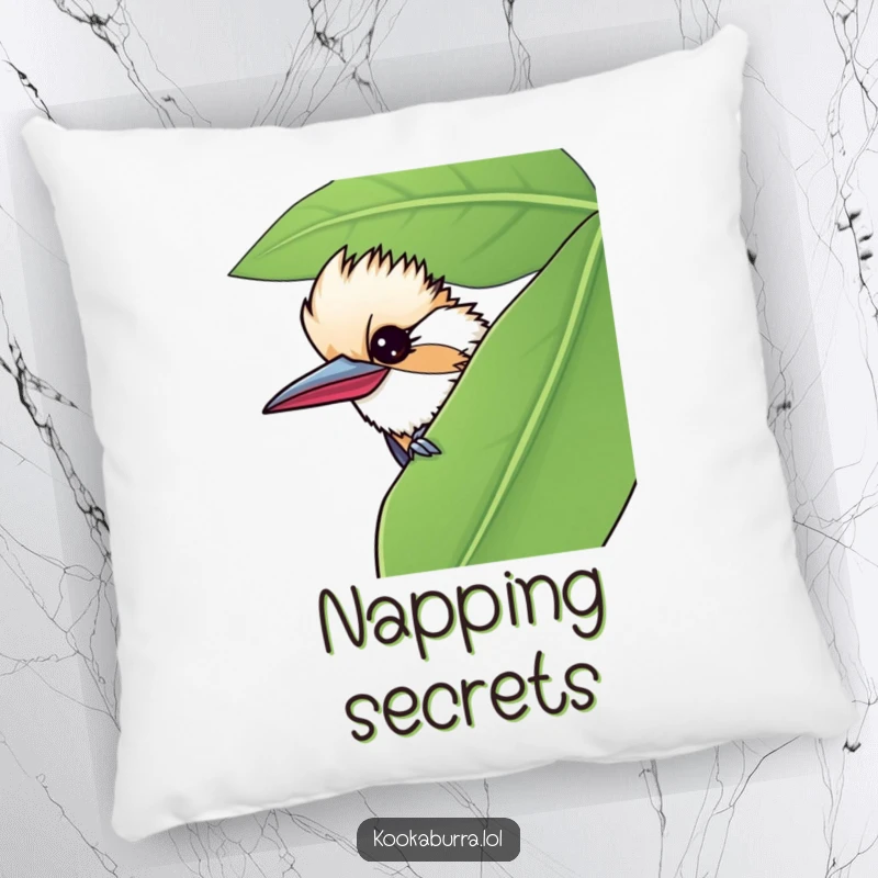 Funny pillow featuring a kookaburra peeking from behind a leaf, giving a mischievous wink for cozy, playful charm.