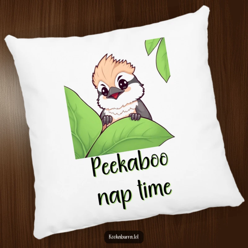 Funny kawaii kookaburra pillow featuring a cute bird peeking with wide, curious eyes from behind a large leaf, adding charm.