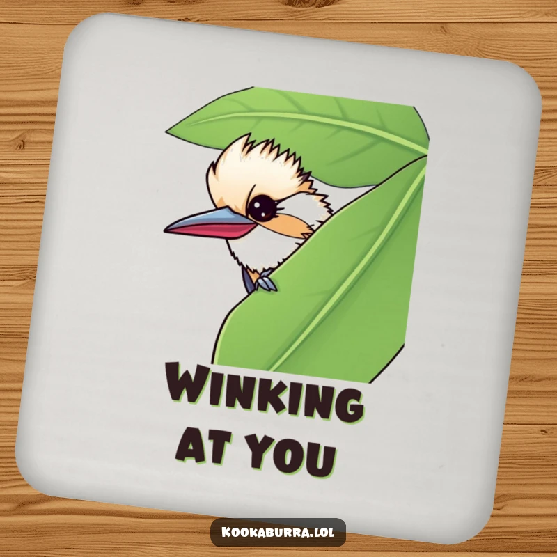 Funny drink coasters with a kookaburra peeking from a leaf, giving a mischievous wink to protect surfaces humorously.