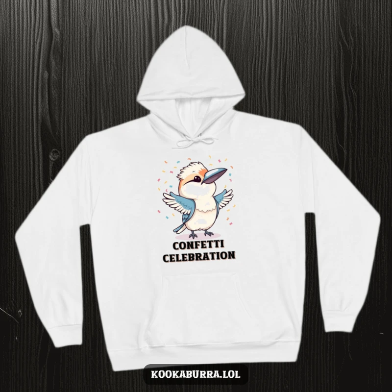 Funny kookaburra joyfully throwing confetti with both wings, depicted on a soft hoodie for ultimate festive coziness.