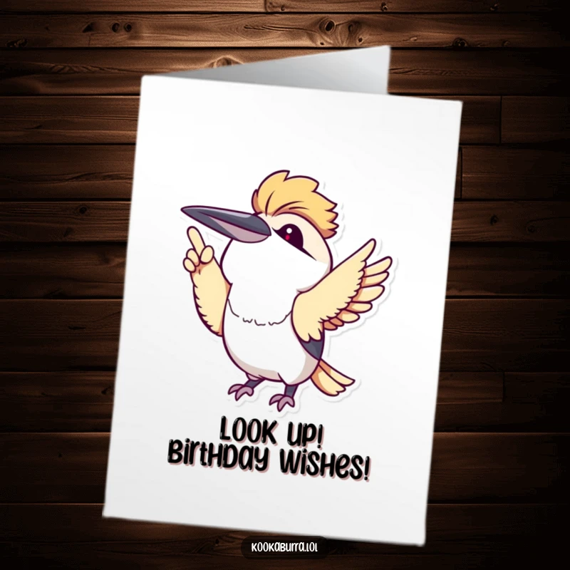 Funny free printable birthday card: a kawaii kookaburra with big eyes excitedly pointing its wing upwards, celebrating joyfully.