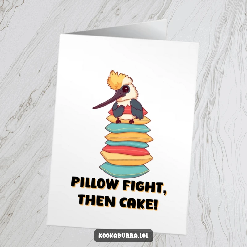 Funny free printable birthday card featuring a whimsical kookaburra expertly balancing a tall stack of colorful, plush pillows with a smile.
