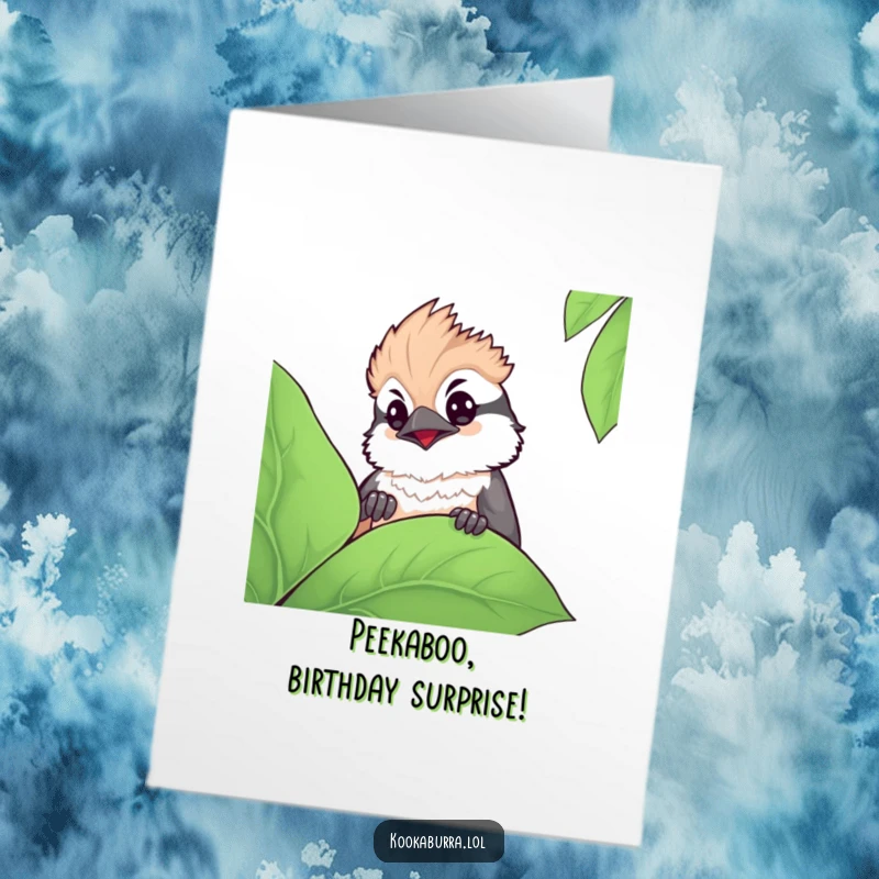 Funny Free Printable Birthday Card: A super cute kawaii kookaburra peeking shyly from behind a large green leaf with curious eyes.