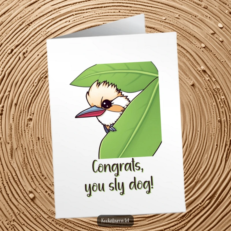 Funny Free Printable Congratulations Card: A kookaburra winks mischievously from behind a leaf, celebrating success. Cheeky downloadable gift.