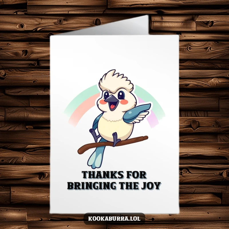 Funny Free Printable Thank You Card: A kookaburra sliding down a rainbow, conveying thanks with cheerful exuberance.