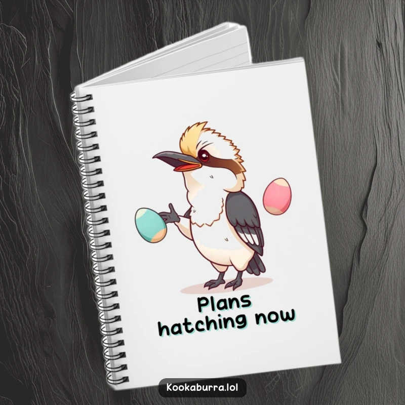 Funny notebook with a kawaii kookaburra comically juggling oversized, wobbly eggs, perfect for note-taking.