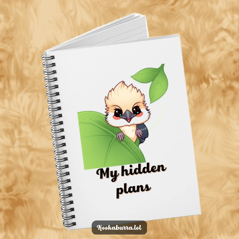 Funny Kawaii Kookaburra notebook, a cute bird peeking from behind a leaf, perfect for jotting down playful thoughts. A delightful funny gift.