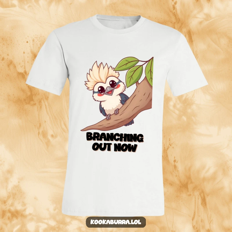 Funny kawaii kookaburra peeking from behind leaves, grinning, cute bird graphic tee, playful nature humor.