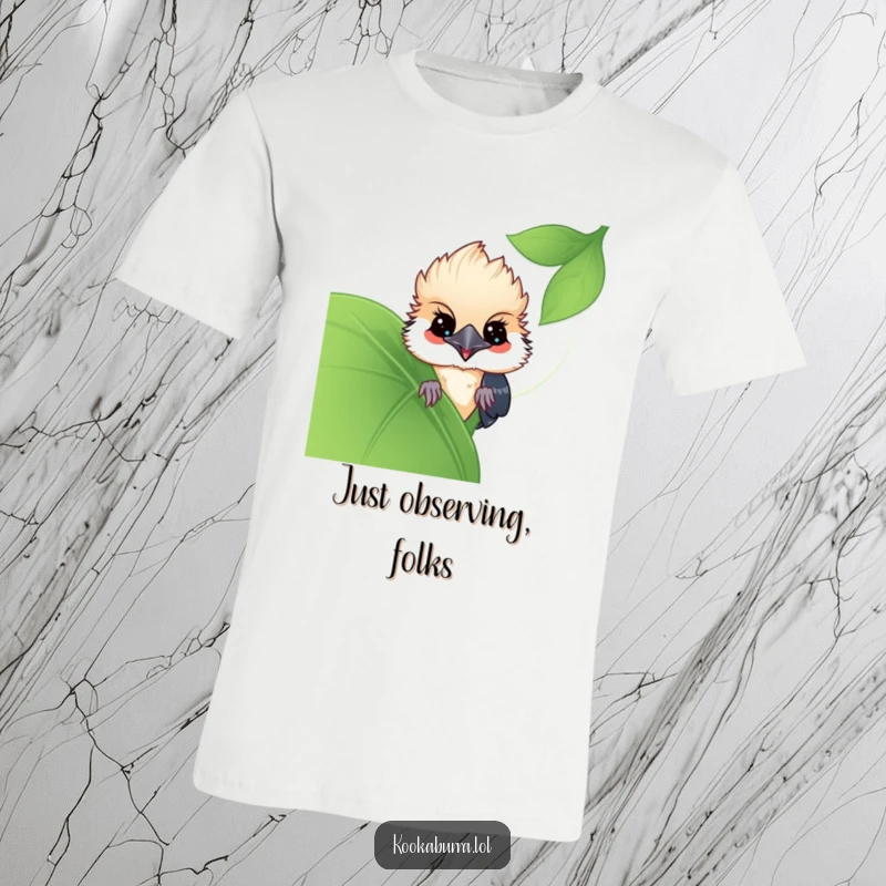 Funny Kawaii Kookaburra t-shirt, a cute bird peeking playfully from behind a large leaf. Perfect for hiding secrets and sharing funny gifts.