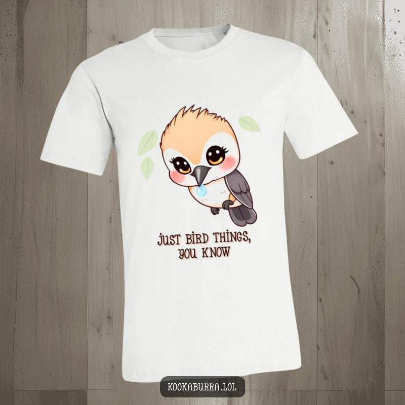 Funny Kookaburra T-Shirt: A wide-eyed kookaburra gazing with hilarious awe at a single, sparkling dewdrop, perfect for bird fans.
