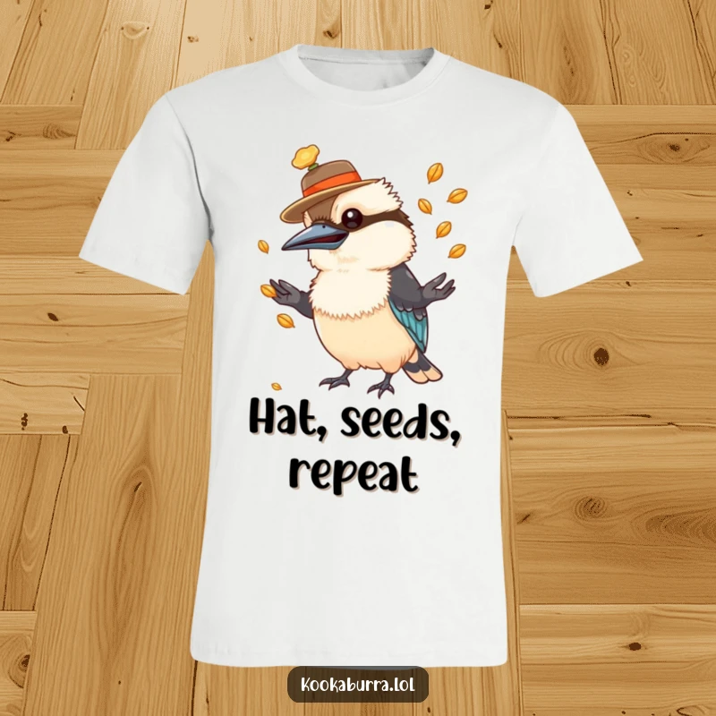 Funny kookaburra t-shirt with a small hat, actively juggling numerous shiny seeds with impressive dexterity.