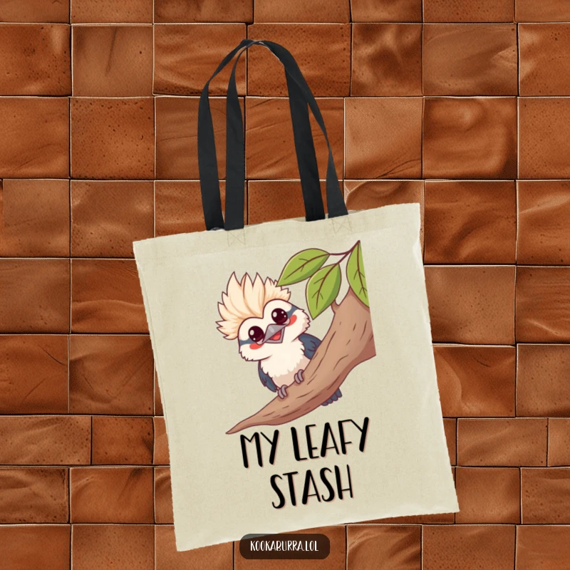 Funny kawaii kookaburra tote bag, peeking from leaves, grinning, cute bird graphic, humorous accessory.